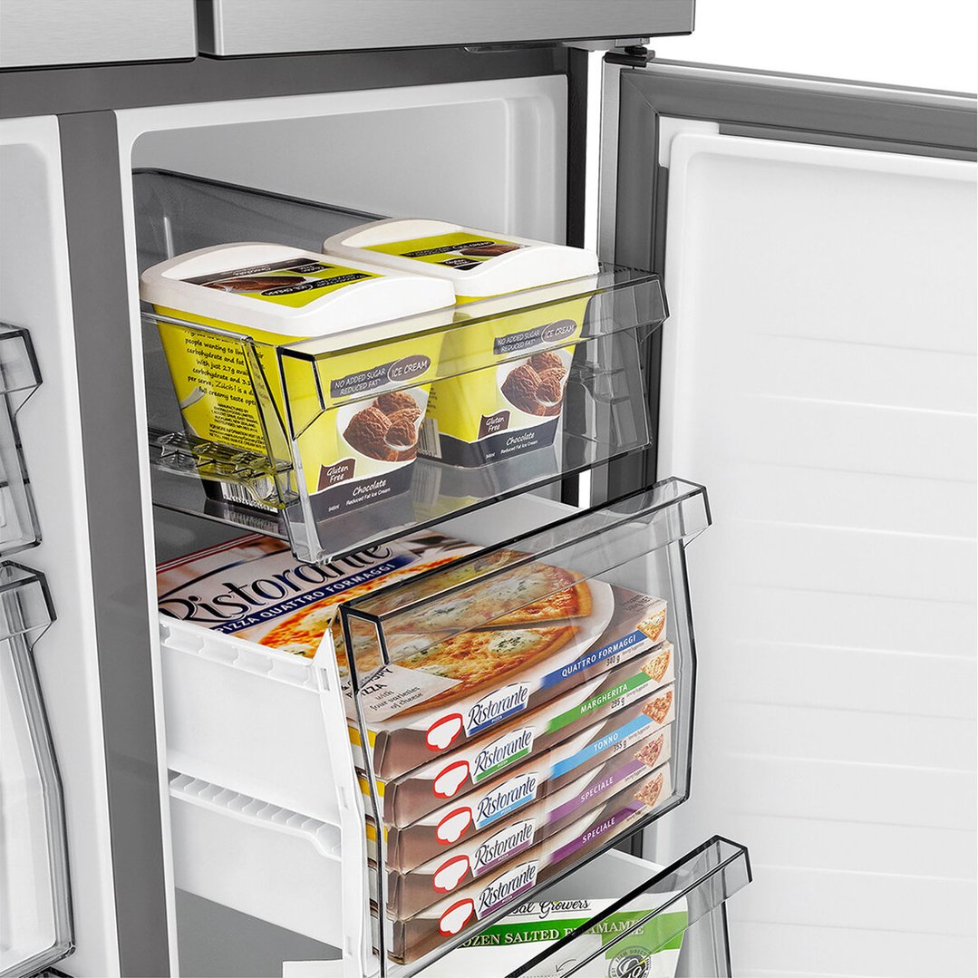 Open freezer compartment of a French door fridge with ice cream and pizzas