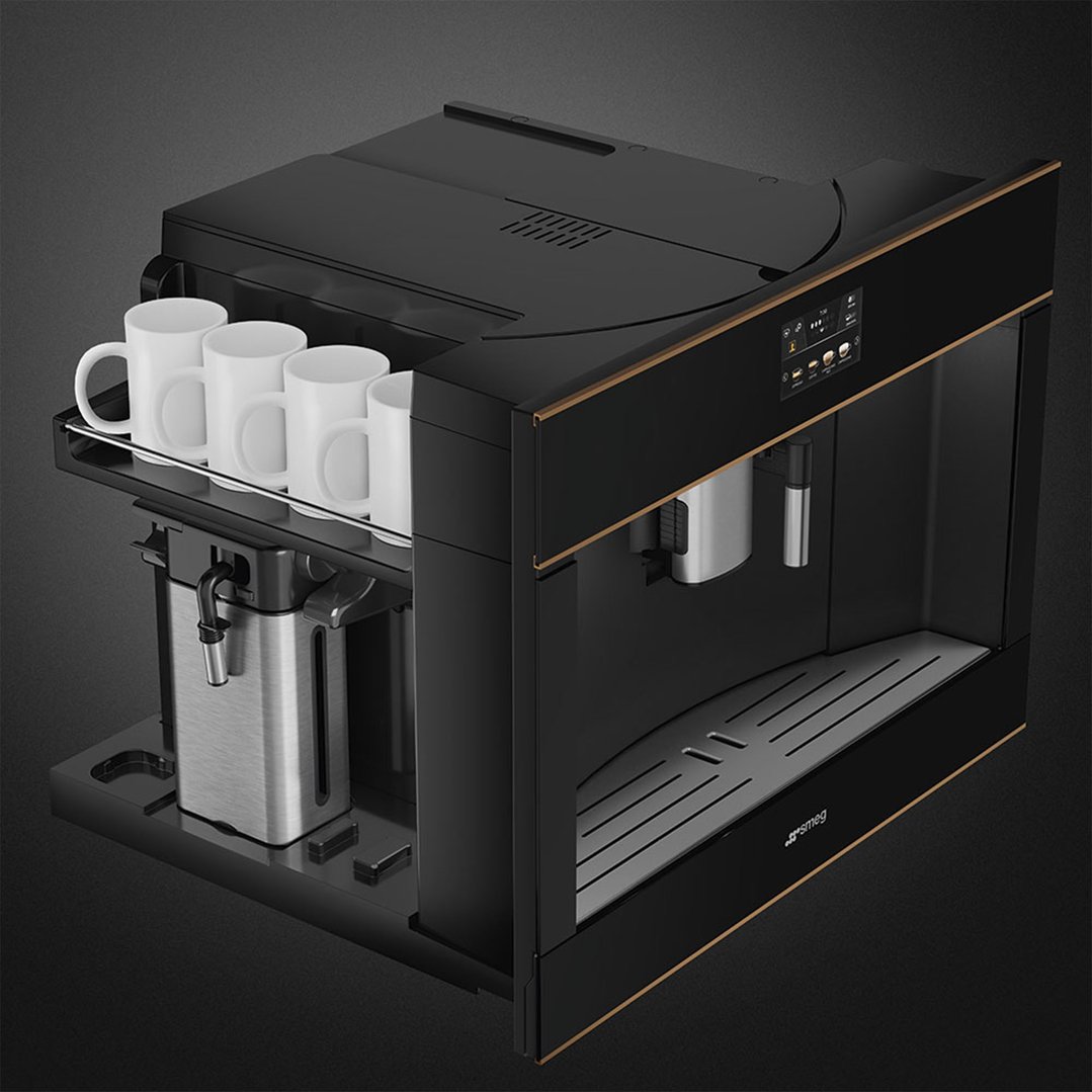 Black built-in coffee machine with four white mugs on a dark background