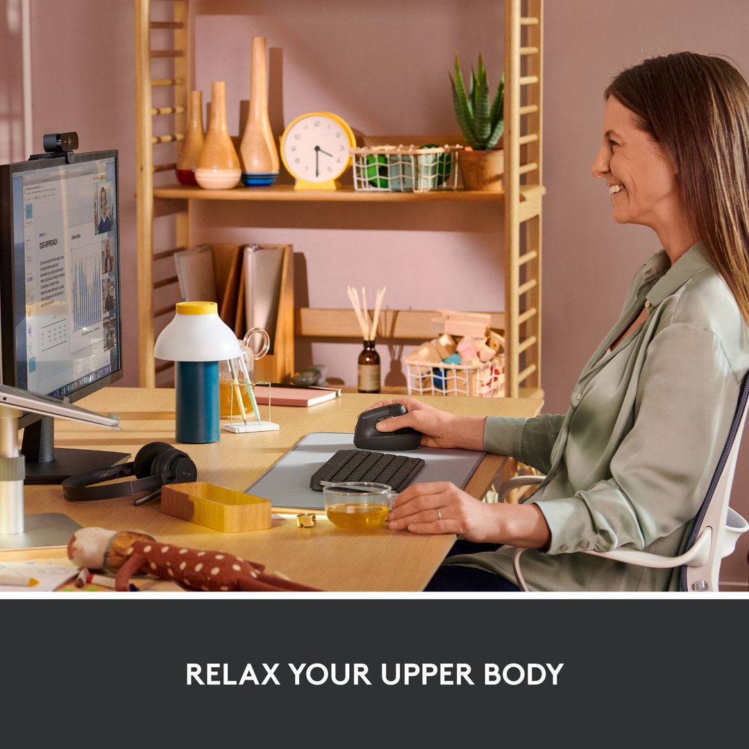 Woman using a LOGITECH Lift Vertical Ergonomic Mouse at a desk with a computer