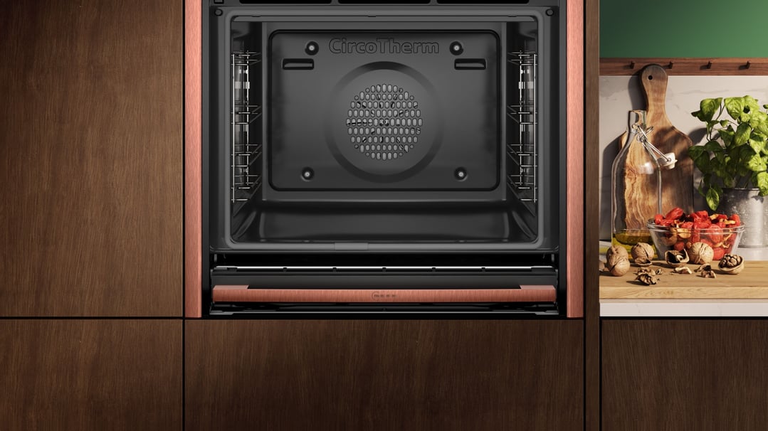 Built-in oven with metallic silver trim in a modern kitchen setting