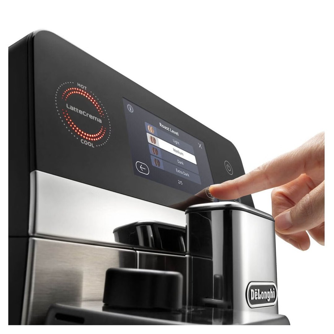 Hand interacting with the touchscreen display of a coffee machine