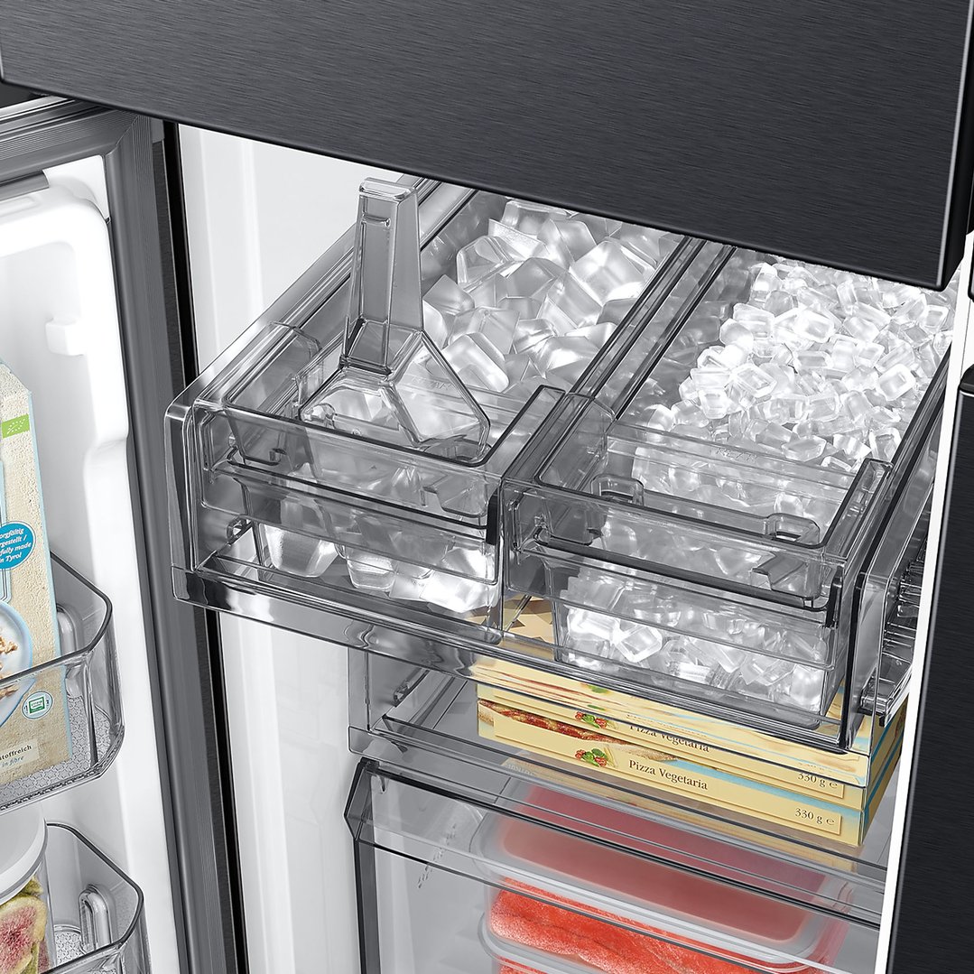 Open refrigerator interior showing ice maker, frozen pizzas, and other food items