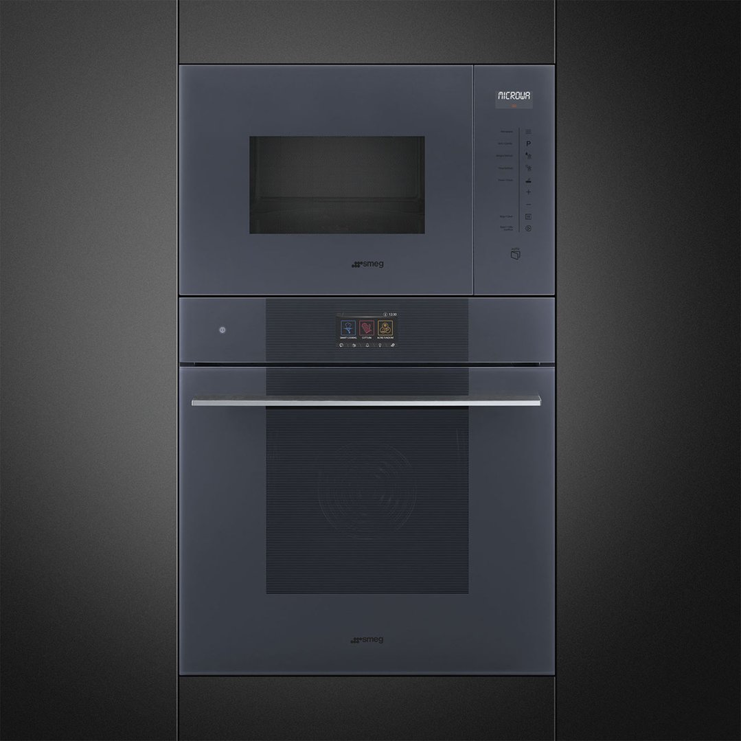 Built-in microwave and oven in a dark grey kitchen cabinet setting