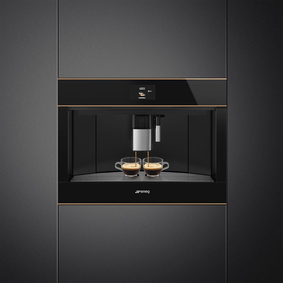 Built-in coffee machine dispensing espresso into two clear cups