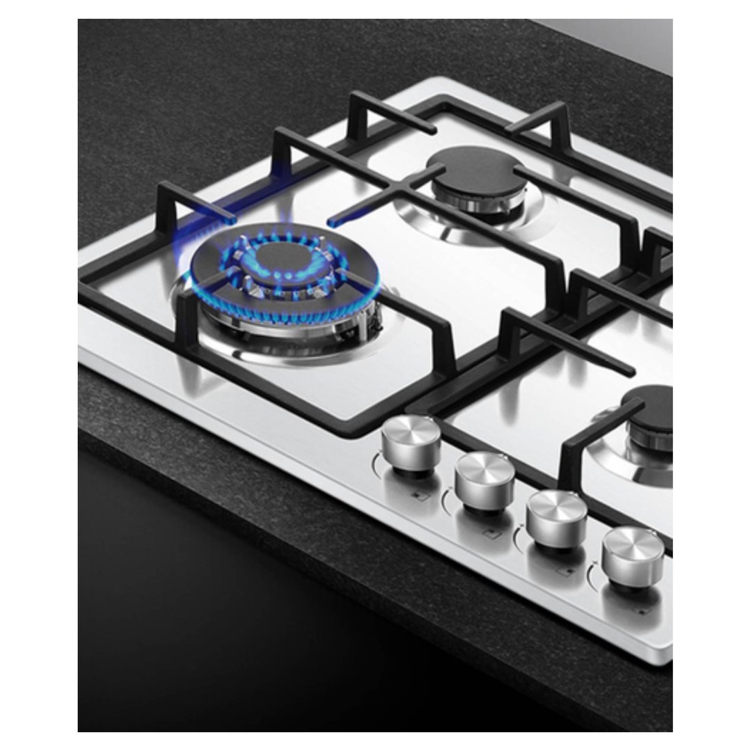 Stainless steel gas cooktop with four burners, one lit, on a dark countertop