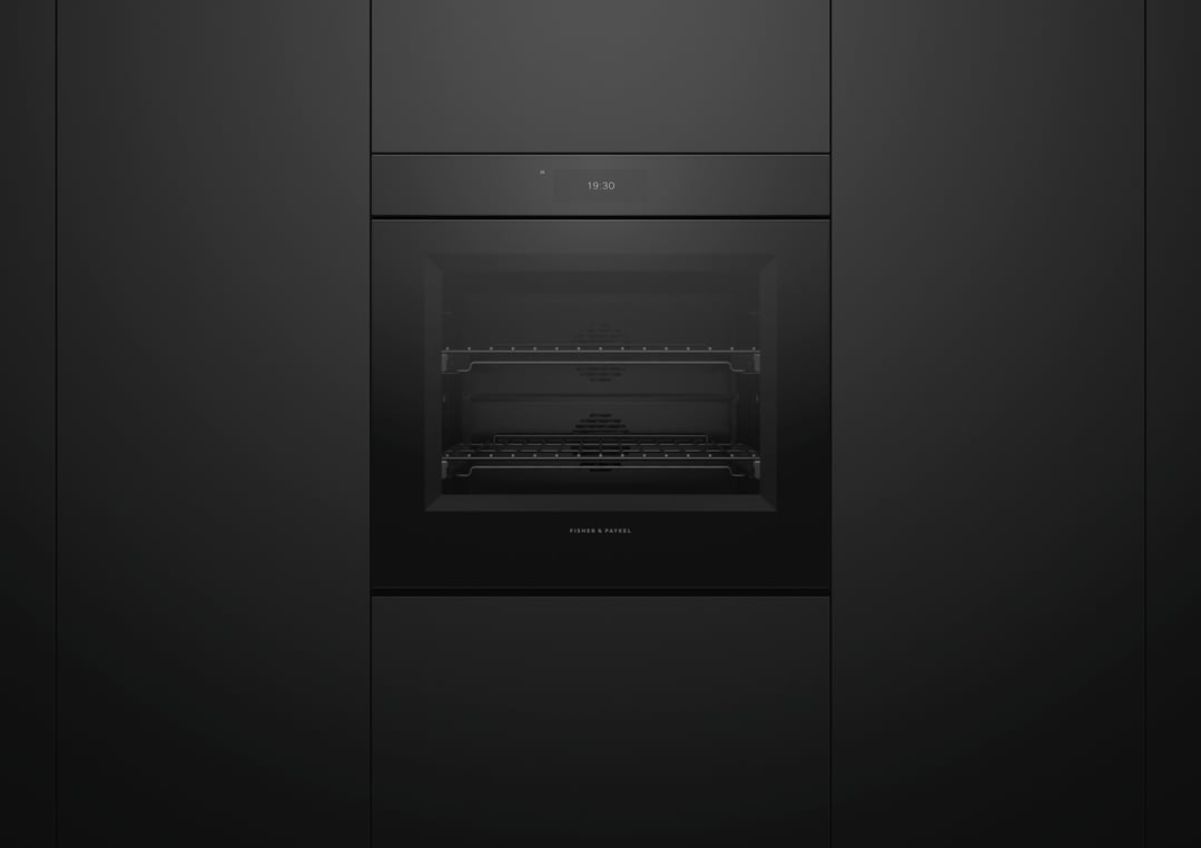 Black Fisher & Paykel oven built into dark cabinetry, displaying 19:30