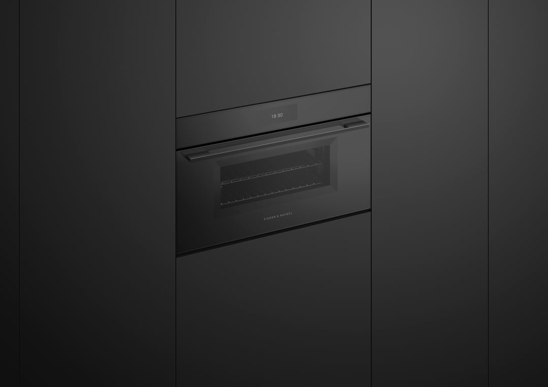 Built-in black combi-steam oven with a digital display showing 19:30