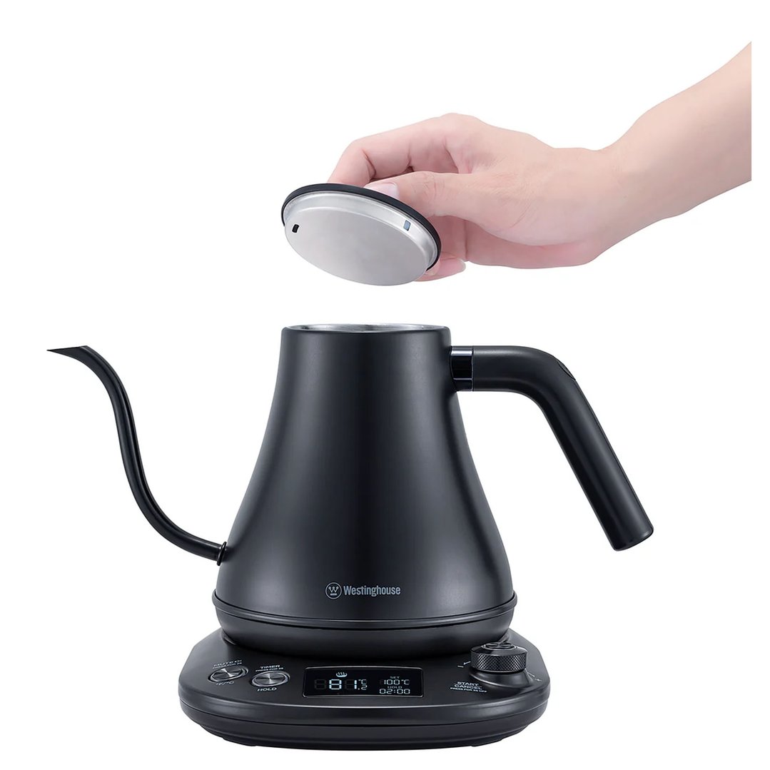Hand removing the lid from a black Westinghouse gooseneck kettle