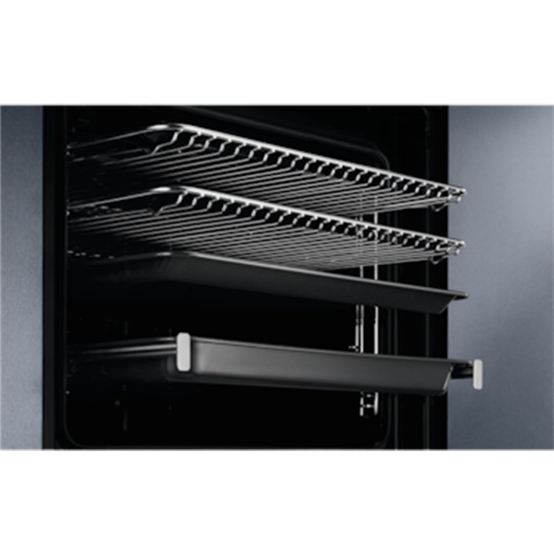 Interior view of an oven with two wire racks and two baking trays