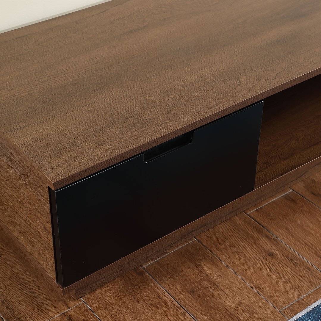 Close up of a dark oak TV cabinet with a black drawer