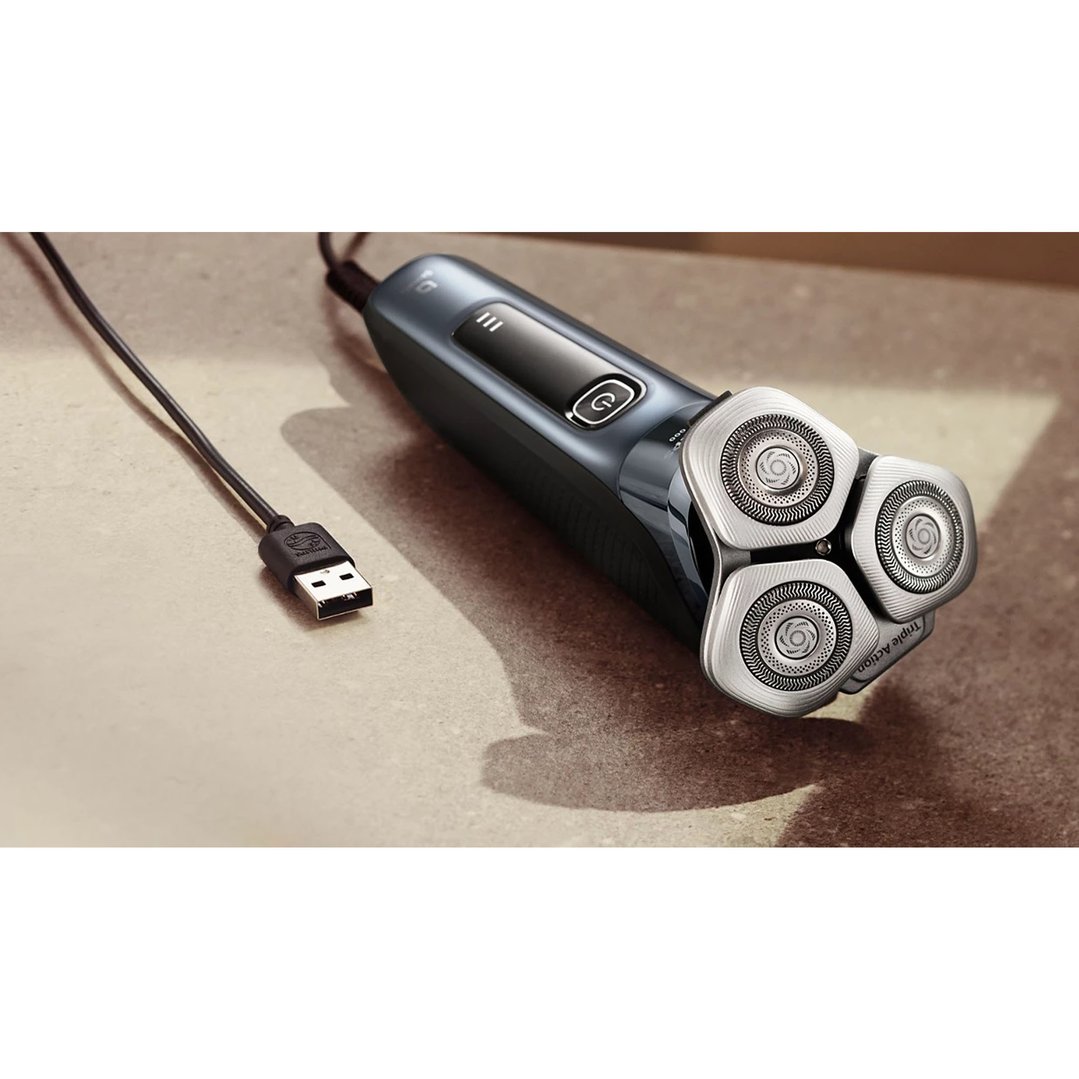 PHILIPS i9000 Wet&Dry Electric Shaver with SkinIQ and USB cable on a counter