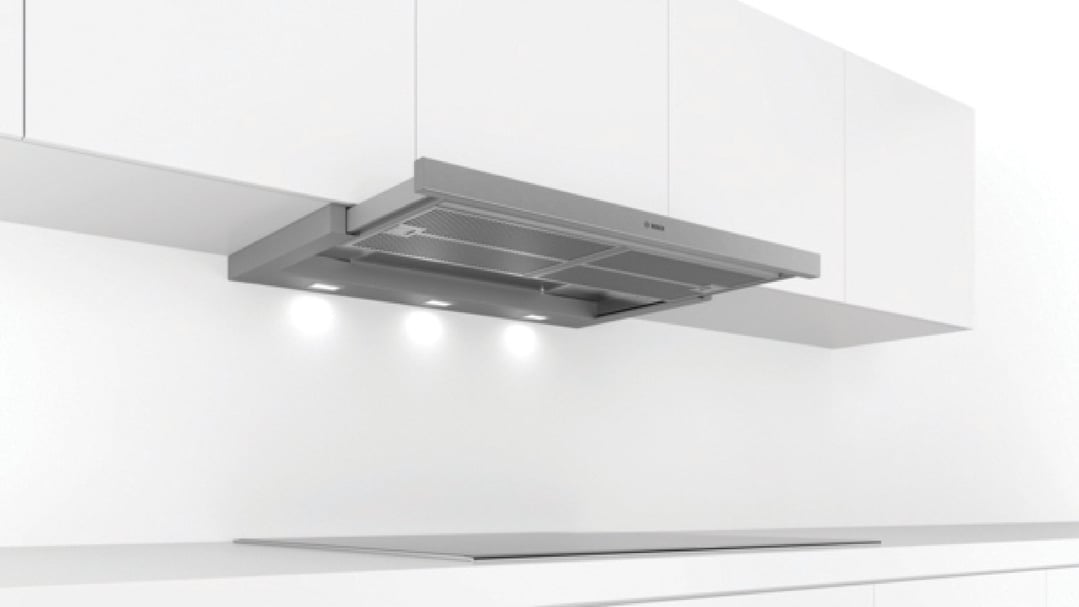 Slideout rangehood installed under white cabinets in a modern kitchen