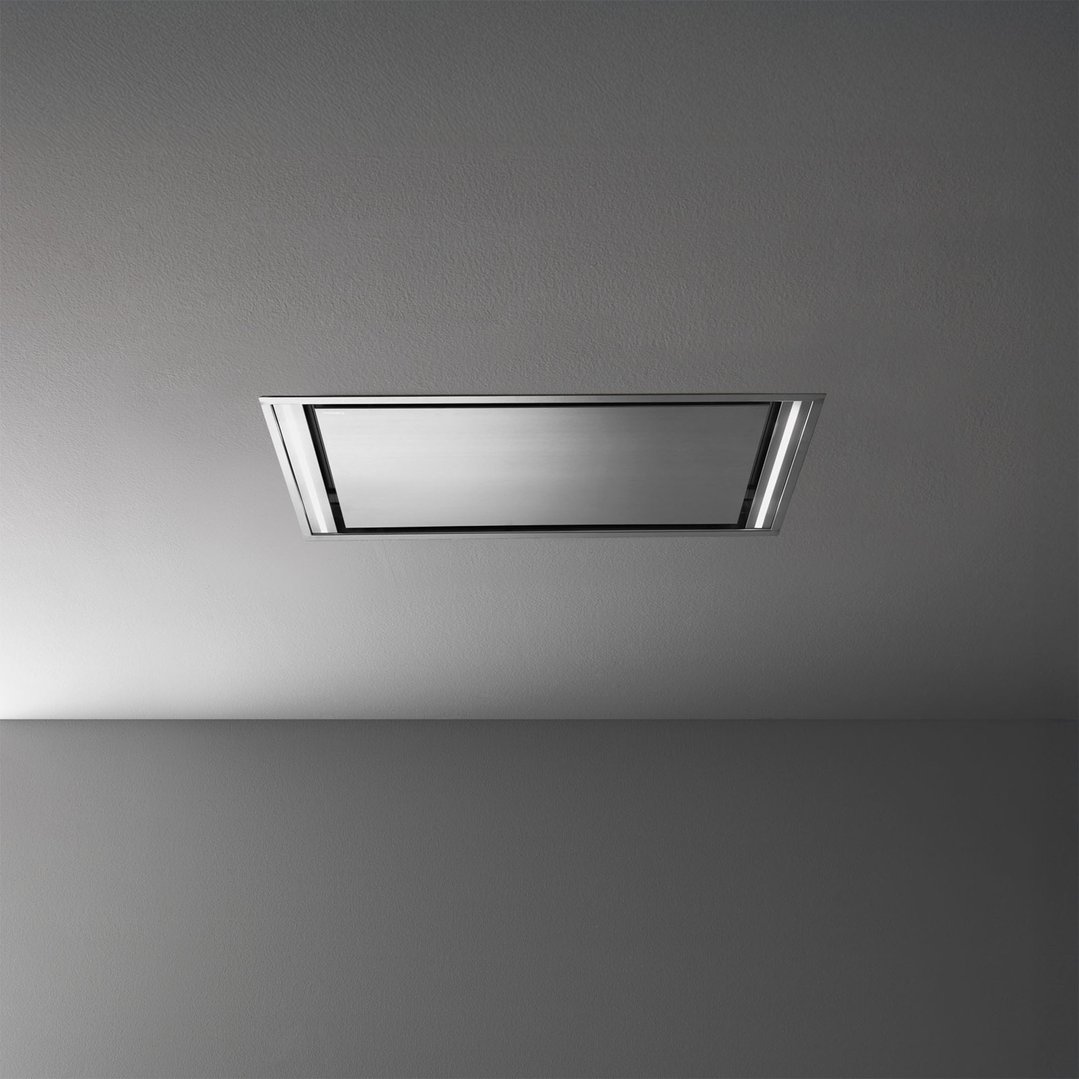 A stainless steel rangehood integrated into a light grey ceiling