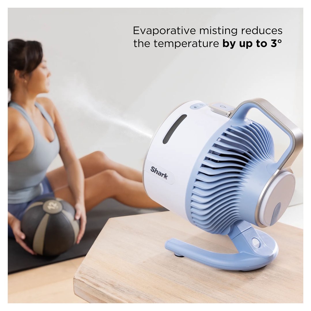 Shark FlexBreeze HydroGo misting portable fan on a wooden table, misting a woman exercising