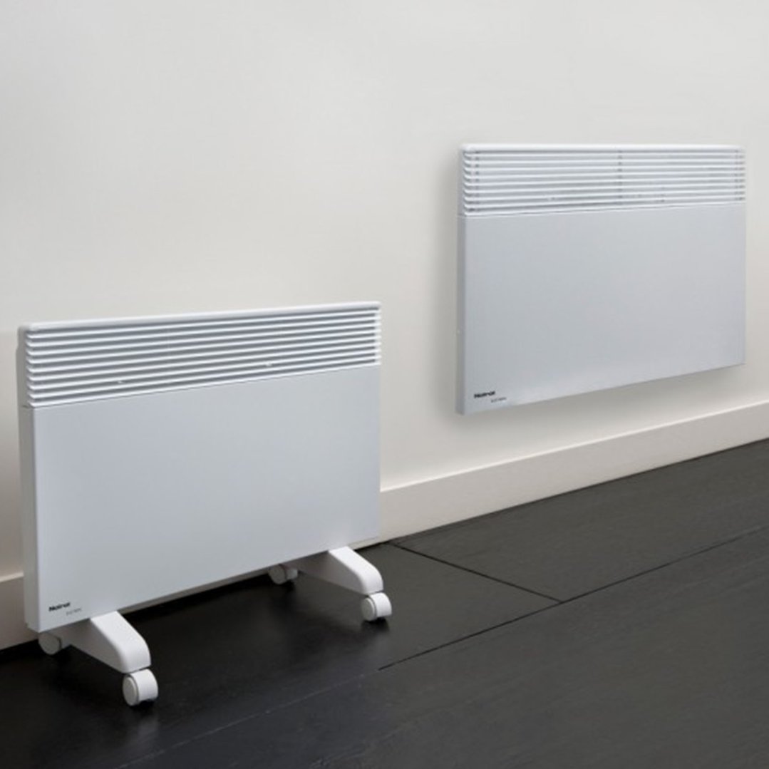 Two white heaters, one on wheels, in a room with a dark floor