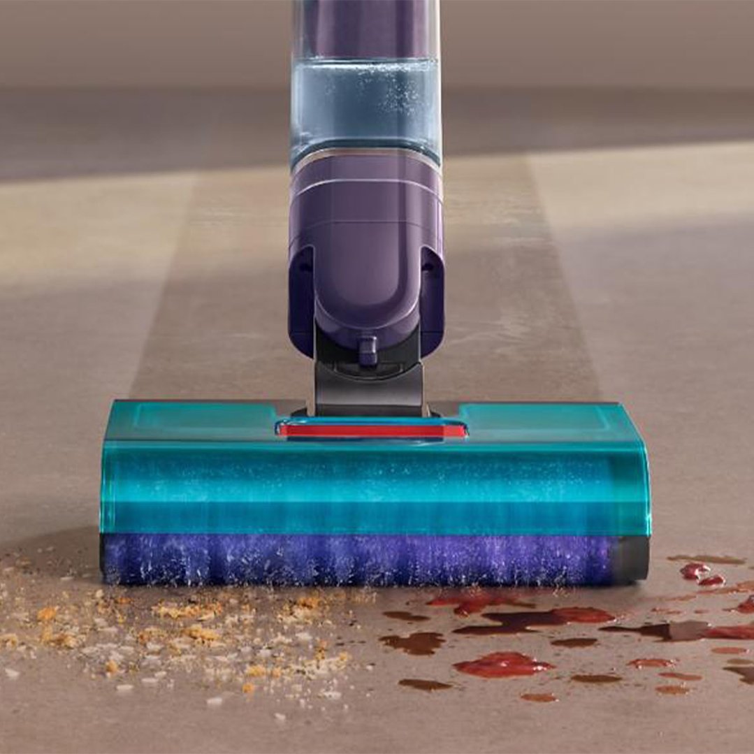 Dyson vacuum cleaner cleaning up spills and debris on a hard floor