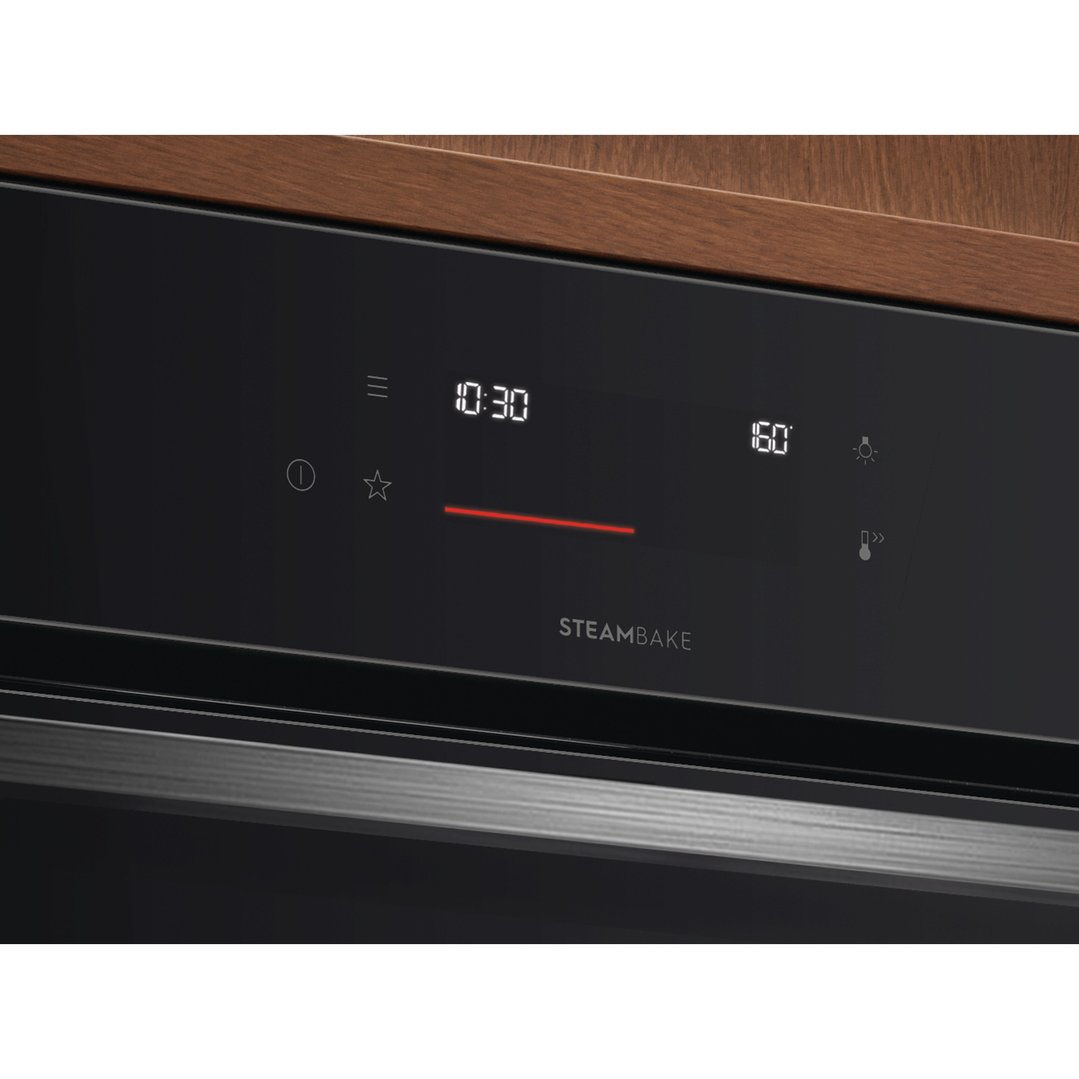 Close up of an oven's black control panel with digital display