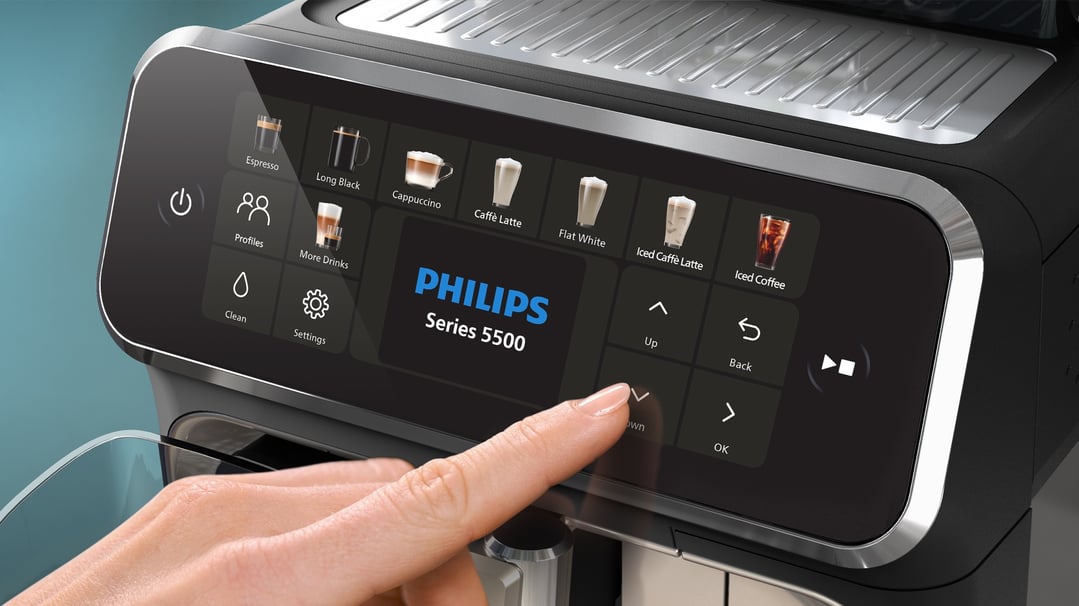 Hand interacting with the touchscreen display of a Philips Series 5500 espresso machine