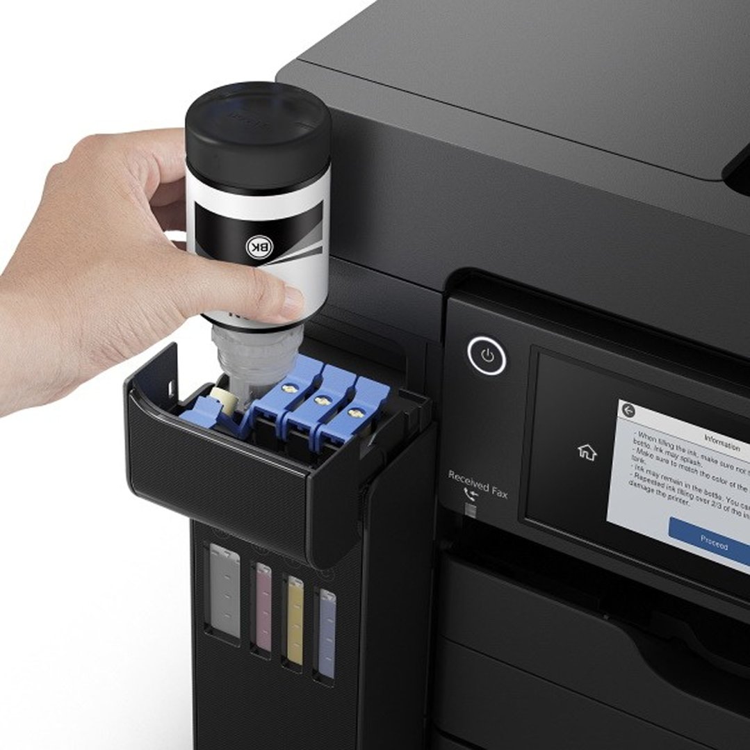 Hand pouring black ink into an EcoTank 4 Colour Multifunction Printer