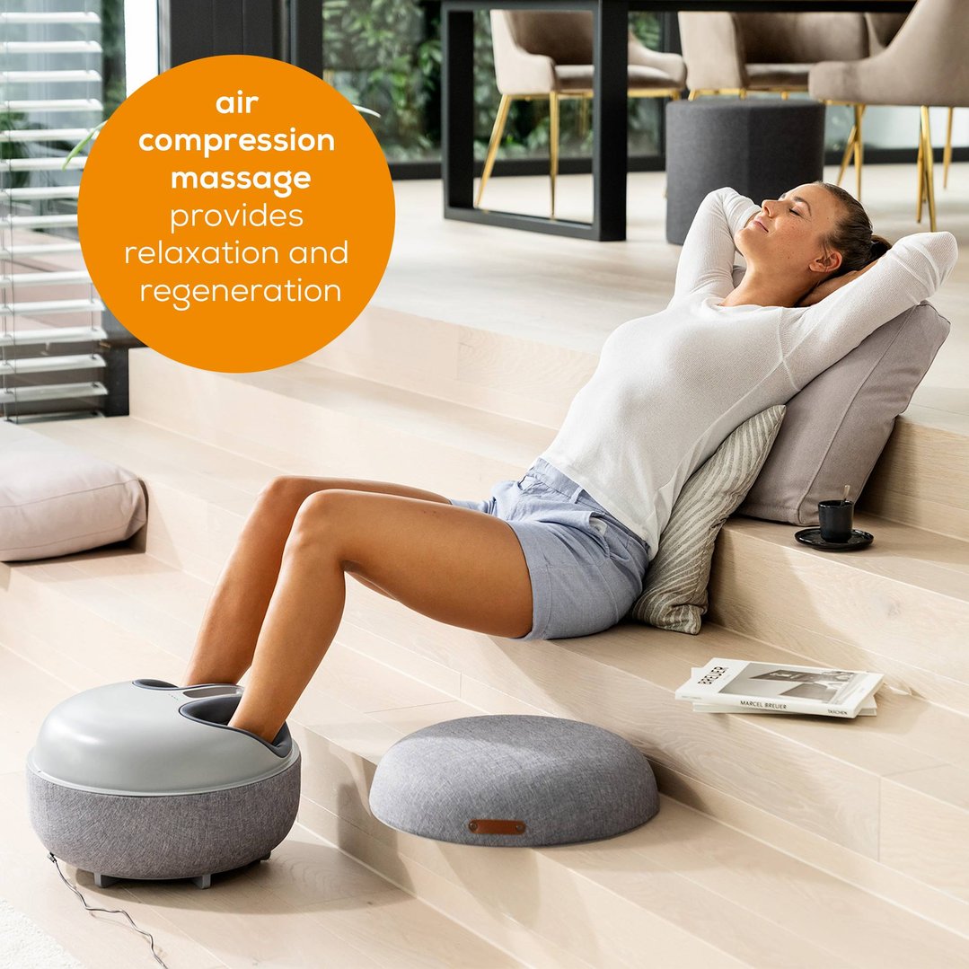 Woman relaxing with feet in a Beurer 2-in-1 Shiatsu Foot Massager
