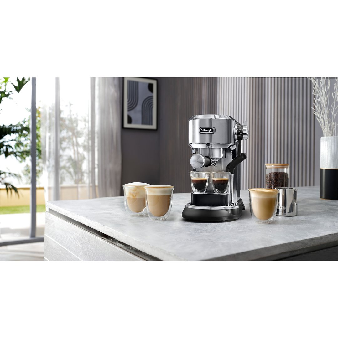 DeLonghi Dedica Maestro Plus Manual Coffee Machine on a counter with coffee drinks
