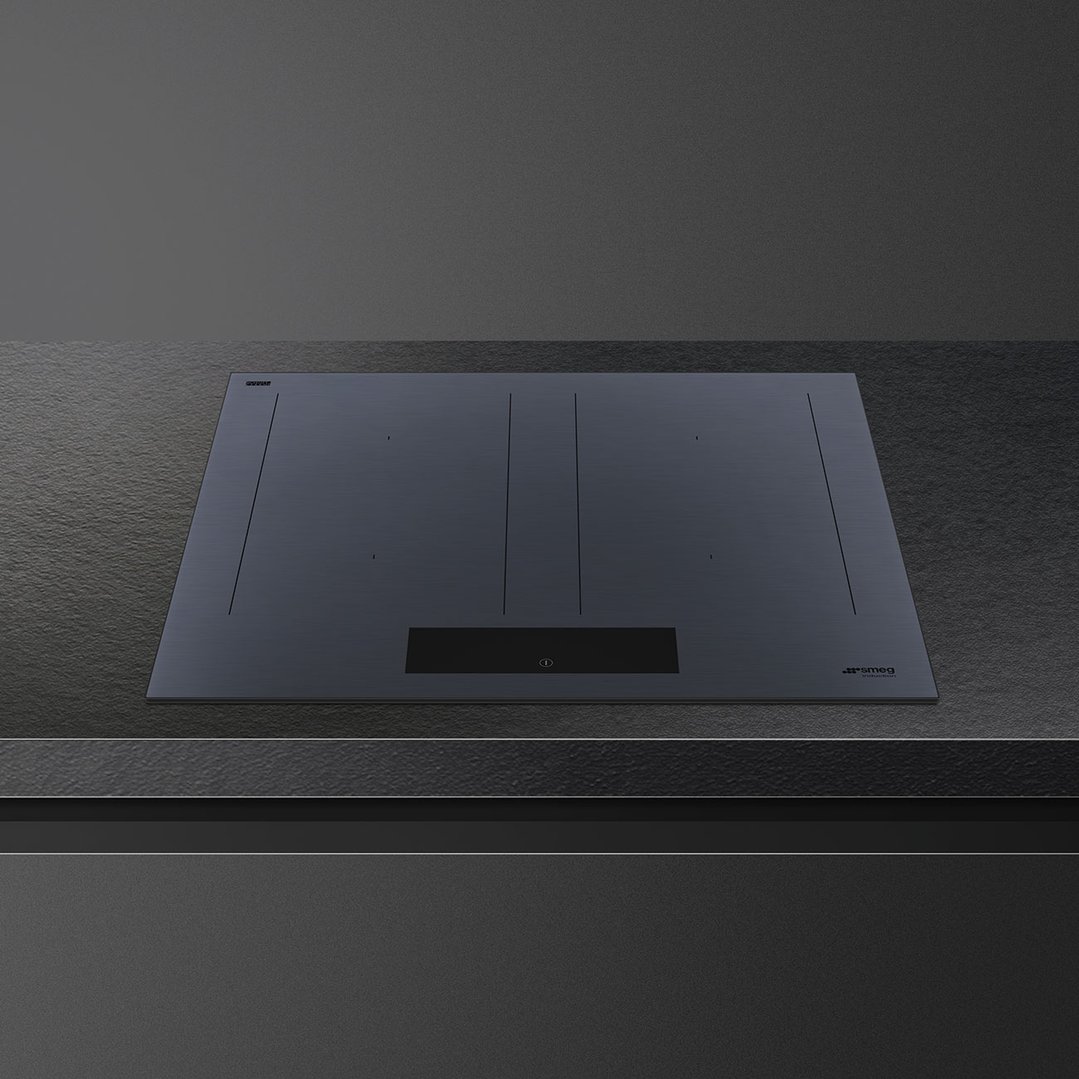 A dark grey induction cooktop with integrated ventilation in a modern kitchen setting