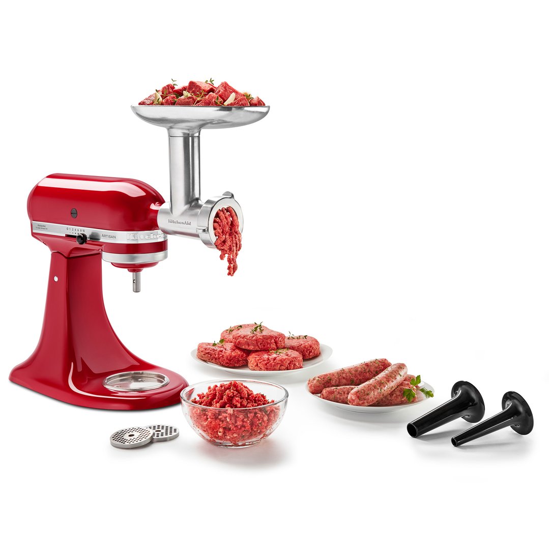 Red stand mixer with metal food grinder attachment making ground meat and sausages