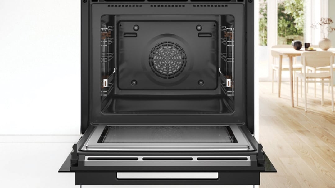Open built-in oven with microwave and steam in a modern kitchen setting