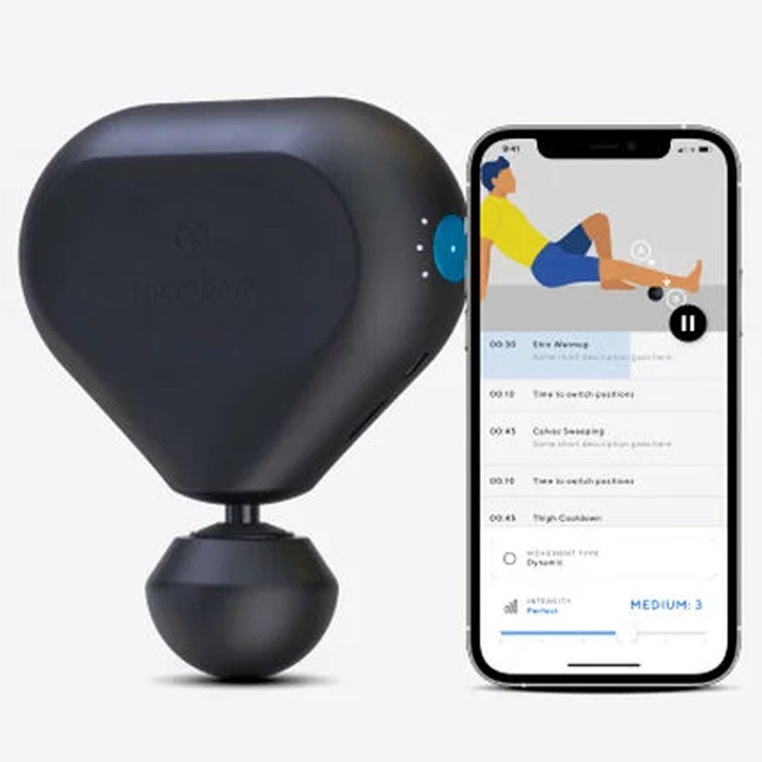 Black Theragun Mini 2.0 massage gun next to a smartphone displaying an app