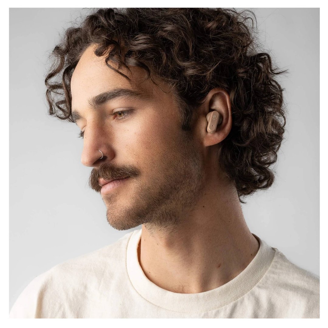 Man wearing a Skullcandy Dime Evo TWS in-ear headset in his right ear