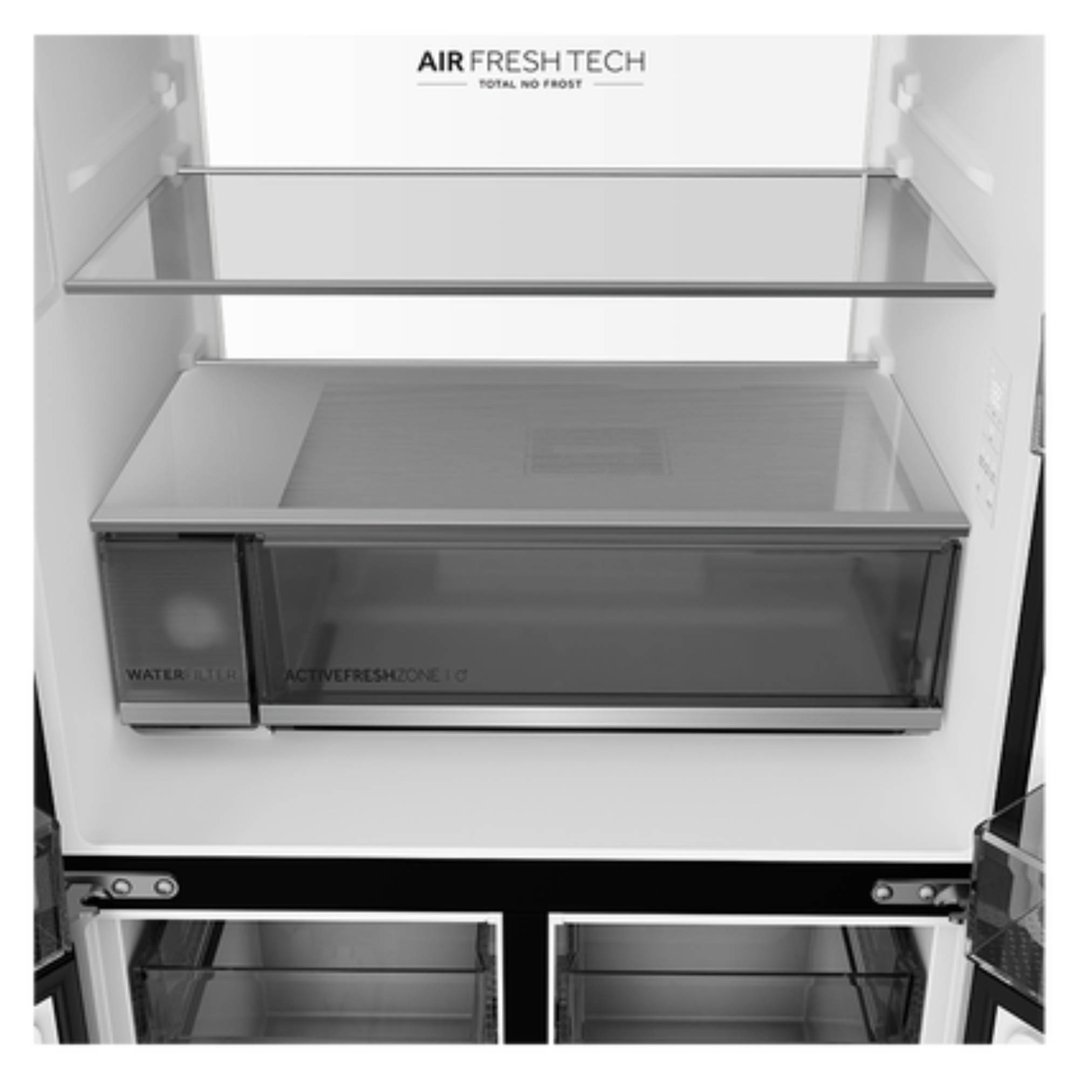 Interior view of a quad door refrigerator freezer with shelves and drawers
