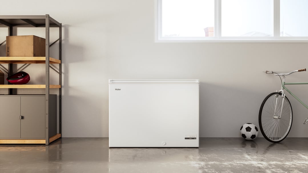 Haier chest freezer in a garage with shelving, bicycle, and soccer ball