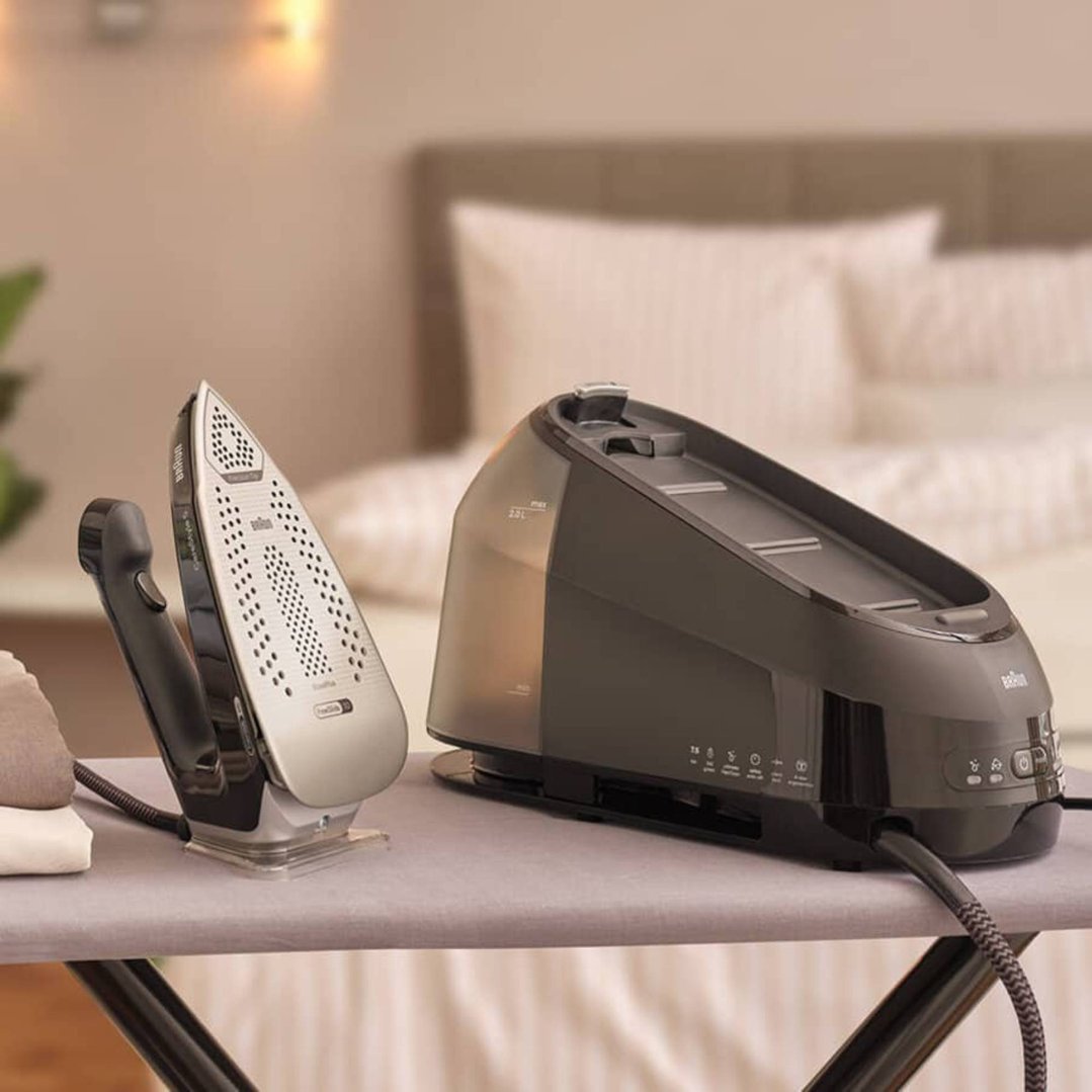 Braun CareStyle 5 steam generator iron on an ironing board in a bedroom