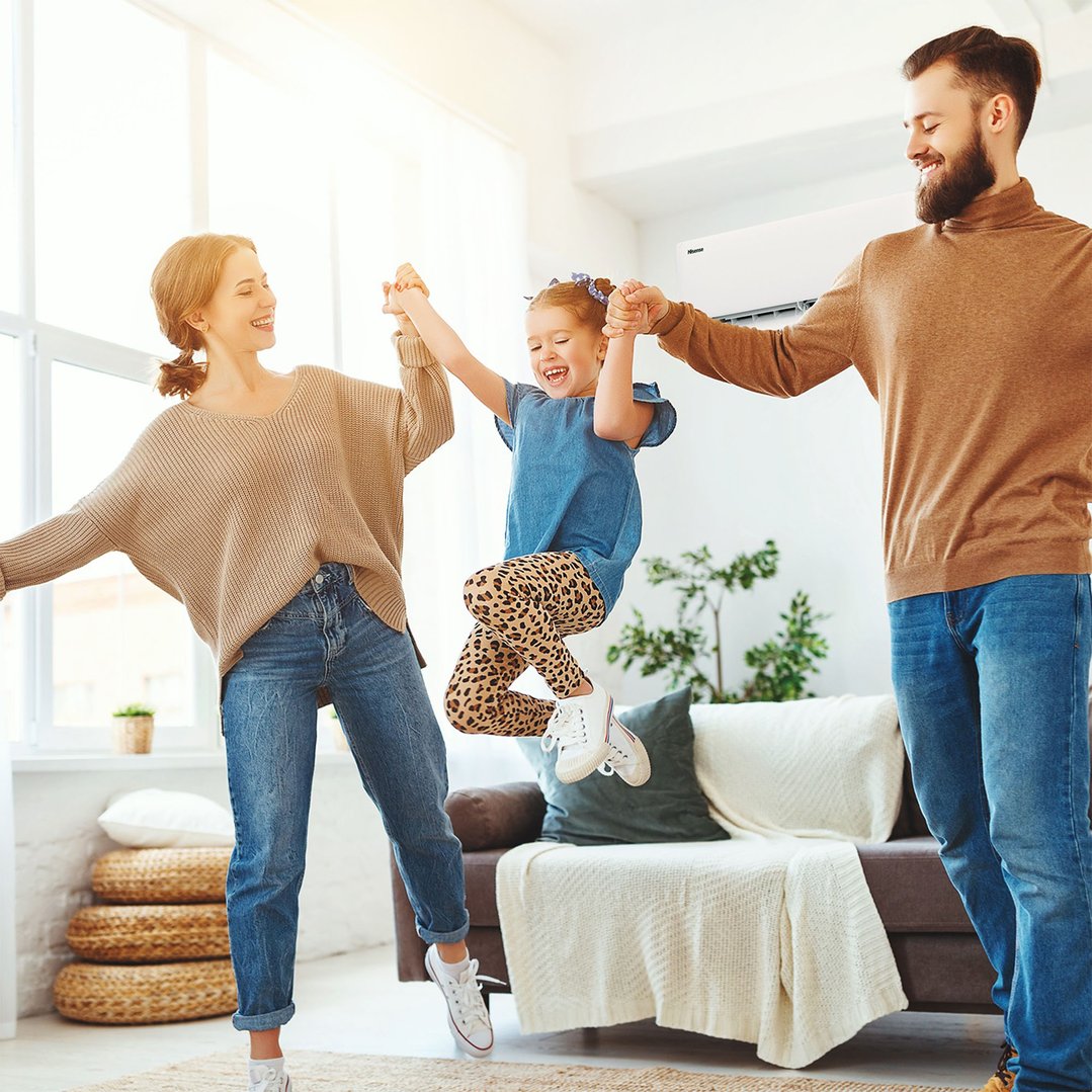 Family playing in a living room with a Hisense air conditioner