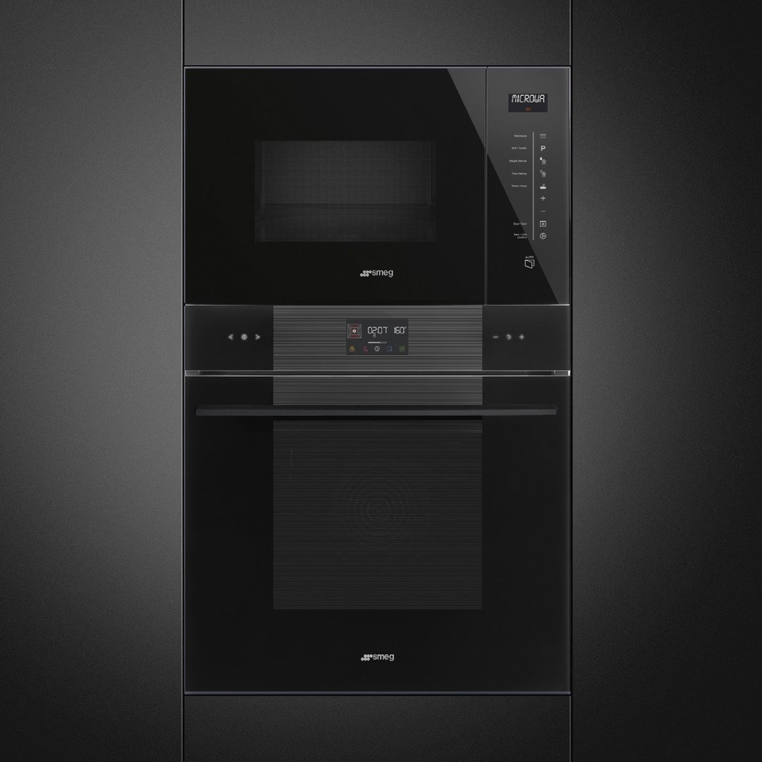 Built-in microwave and oven in a dark kitchen cabinet