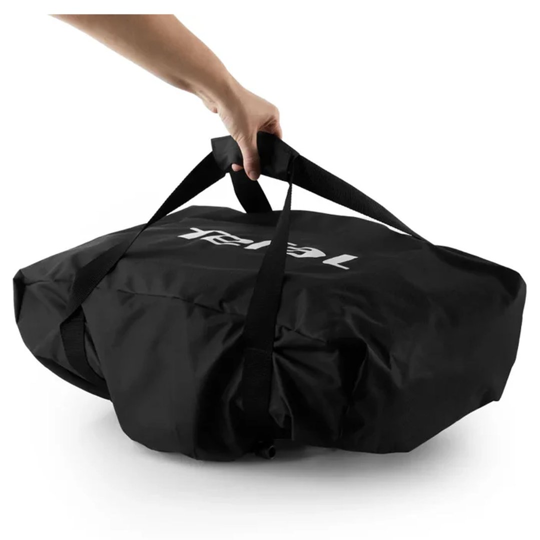Hand holding the black TEFAL Pizza Pronto Transport Bag by its straps