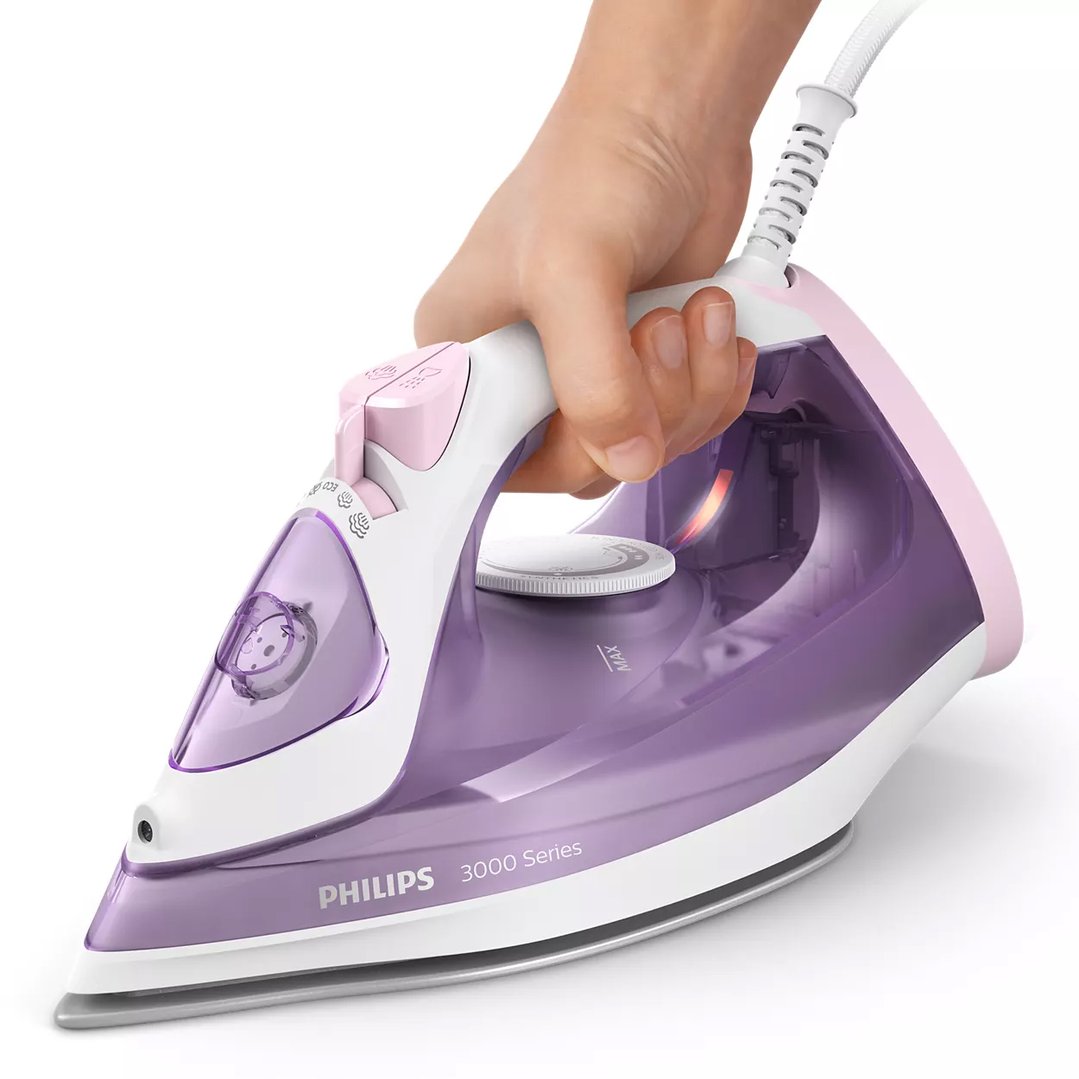 Hand holding a Philips Series 3000 steam iron in purple and pink