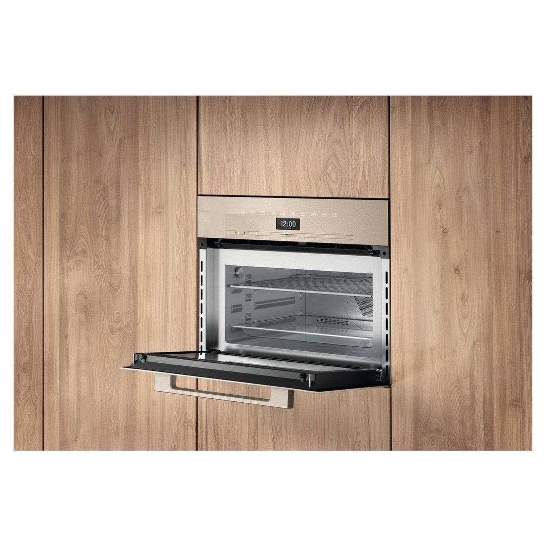 Pearl beige speed oven with door open, built into wooden cabinetry