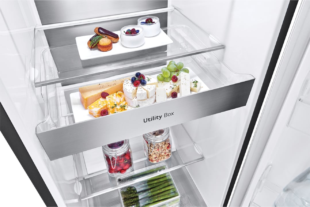 Open fridge interior with food items on shelves and in the utility box