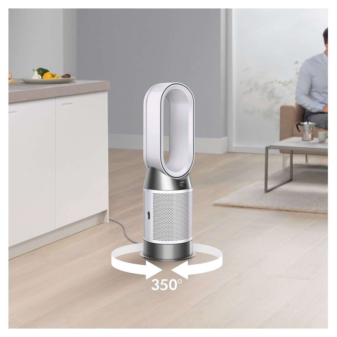 Dyson air purifier in a living room with a man on a sofa