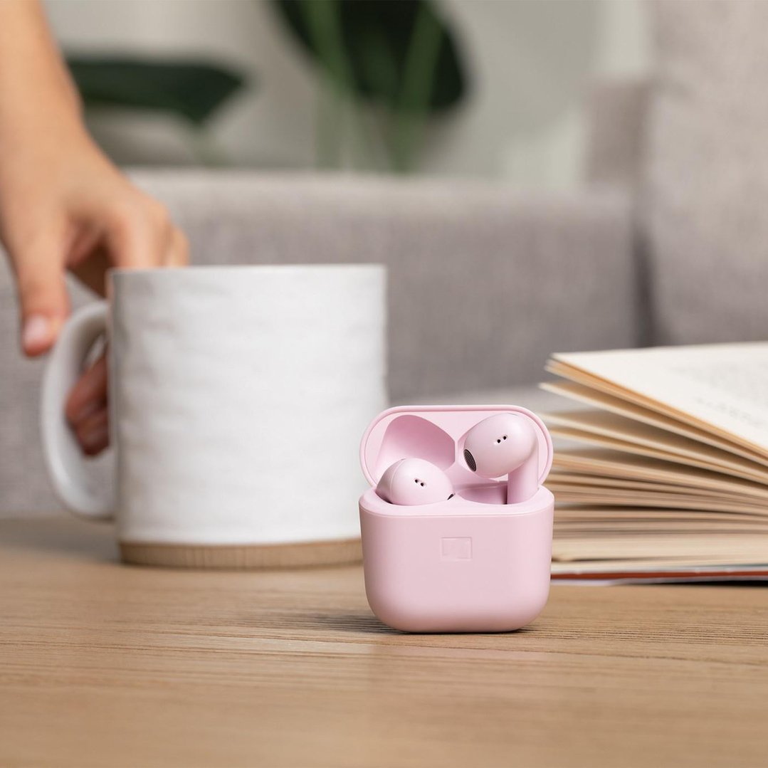 Pink Sennheiser ACCENTUM Open Wireless In-ear Headphones in case on a wooden table
