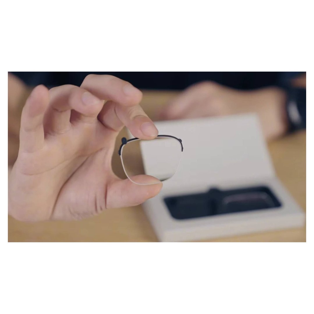 Close up of hands holding a single glasses prescription frame