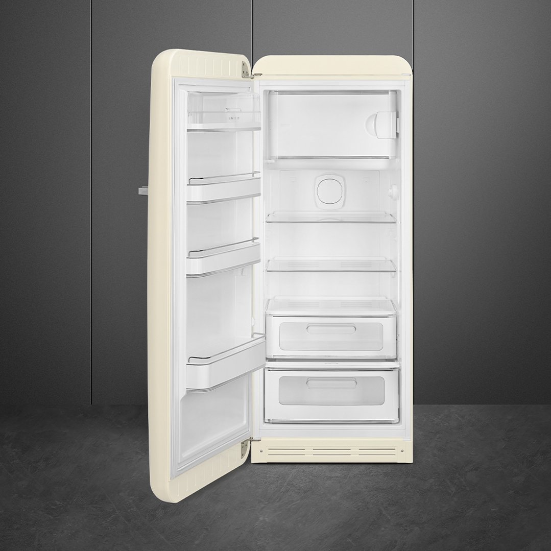Cream retro refrigerator with the door open in a dark grey room
