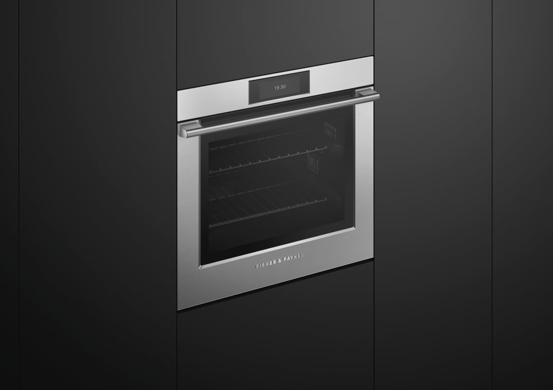 A stainless steel Fisher & Paykel oven built into dark cabinetry