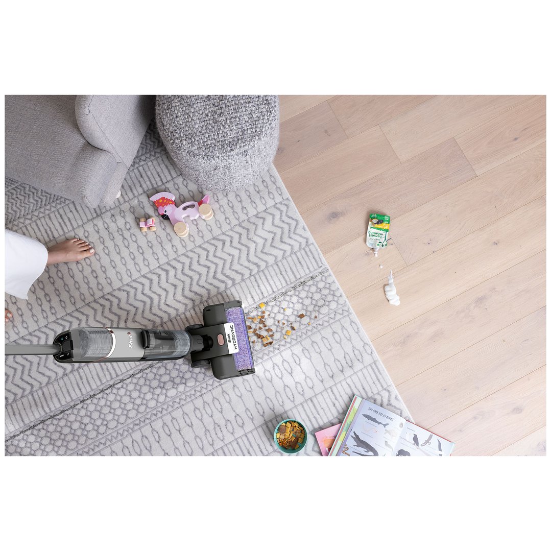 Shark HydroVac cordless 3-in-1 cleaner cleaning up spills on a rug and hardwood floor