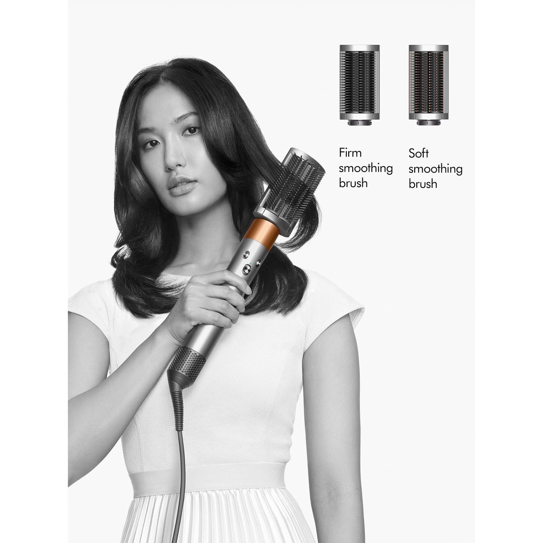 Woman using a Dyson Airwrap multi-styler & dryer with a smoothing brush attachment