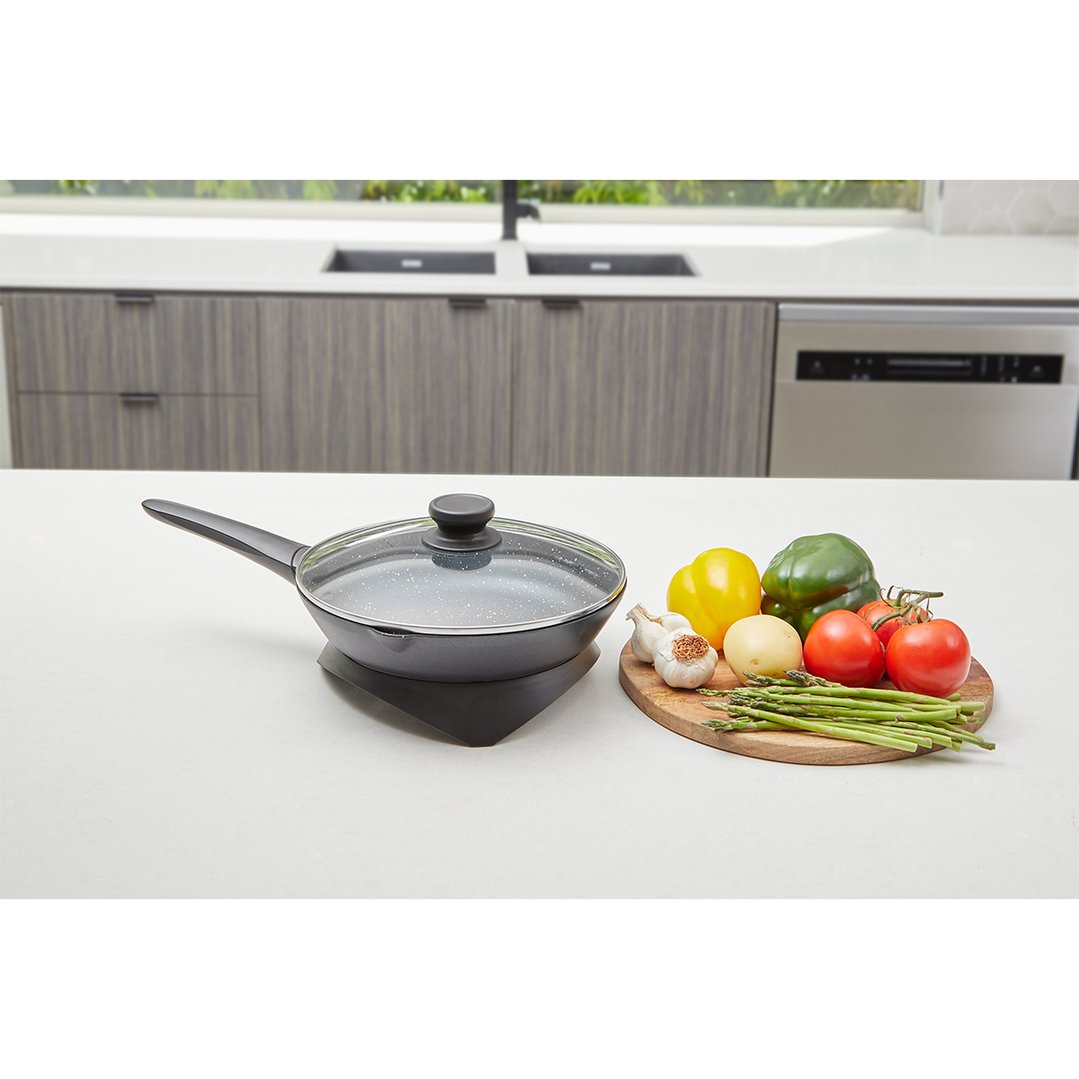 Westinghouse 26cm Electric Skillet with lid and vegetables on a kitchen counter