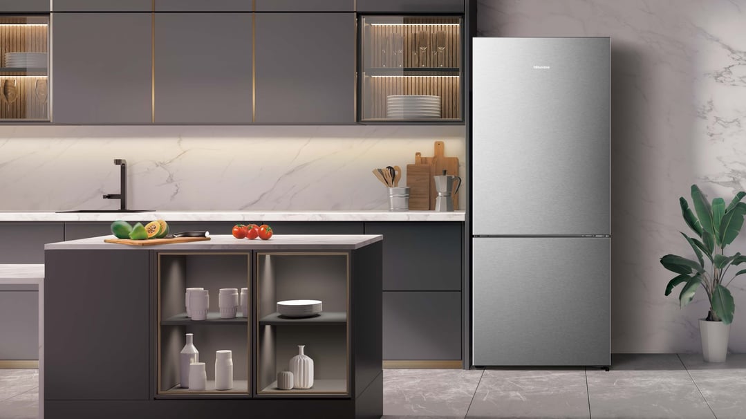 Silver Hisense bottom mount fridge in a modern kitchen with island and marble backsplash