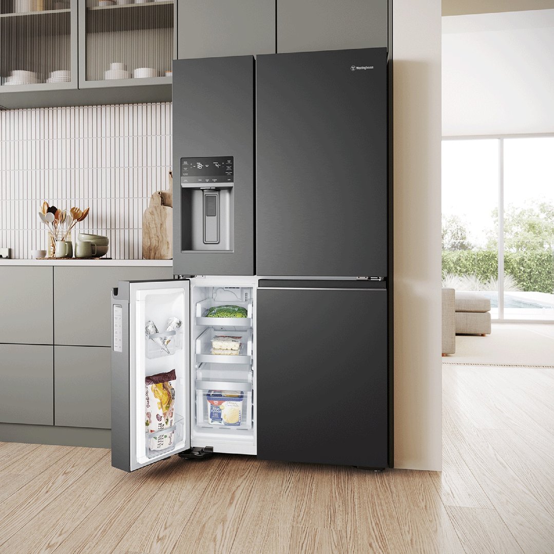 Matte black quad door fridge with open freezer drawer in a modern kitchen