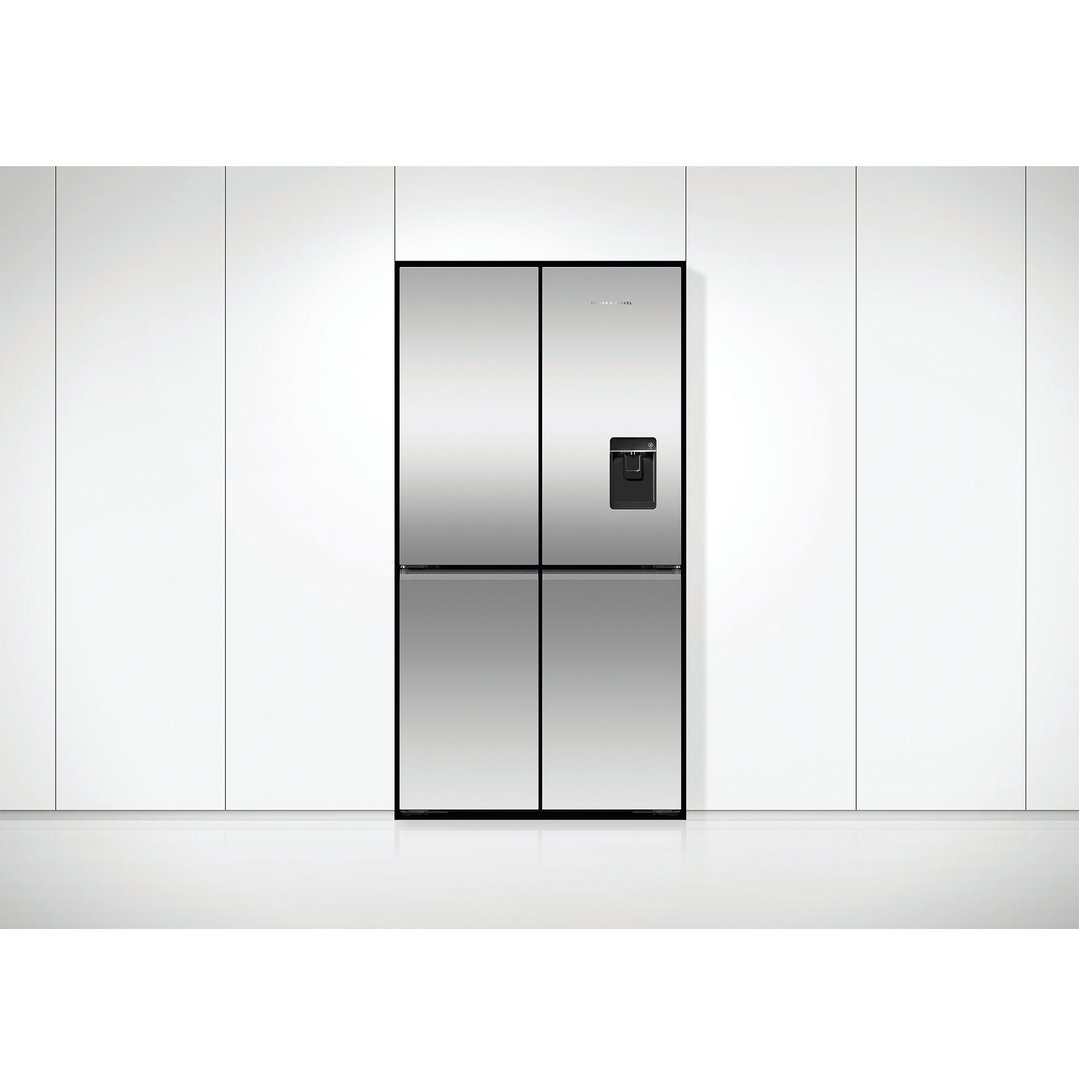 Stainless steel quad door refrigerator freezer with ice and water dispenser in a kitchen